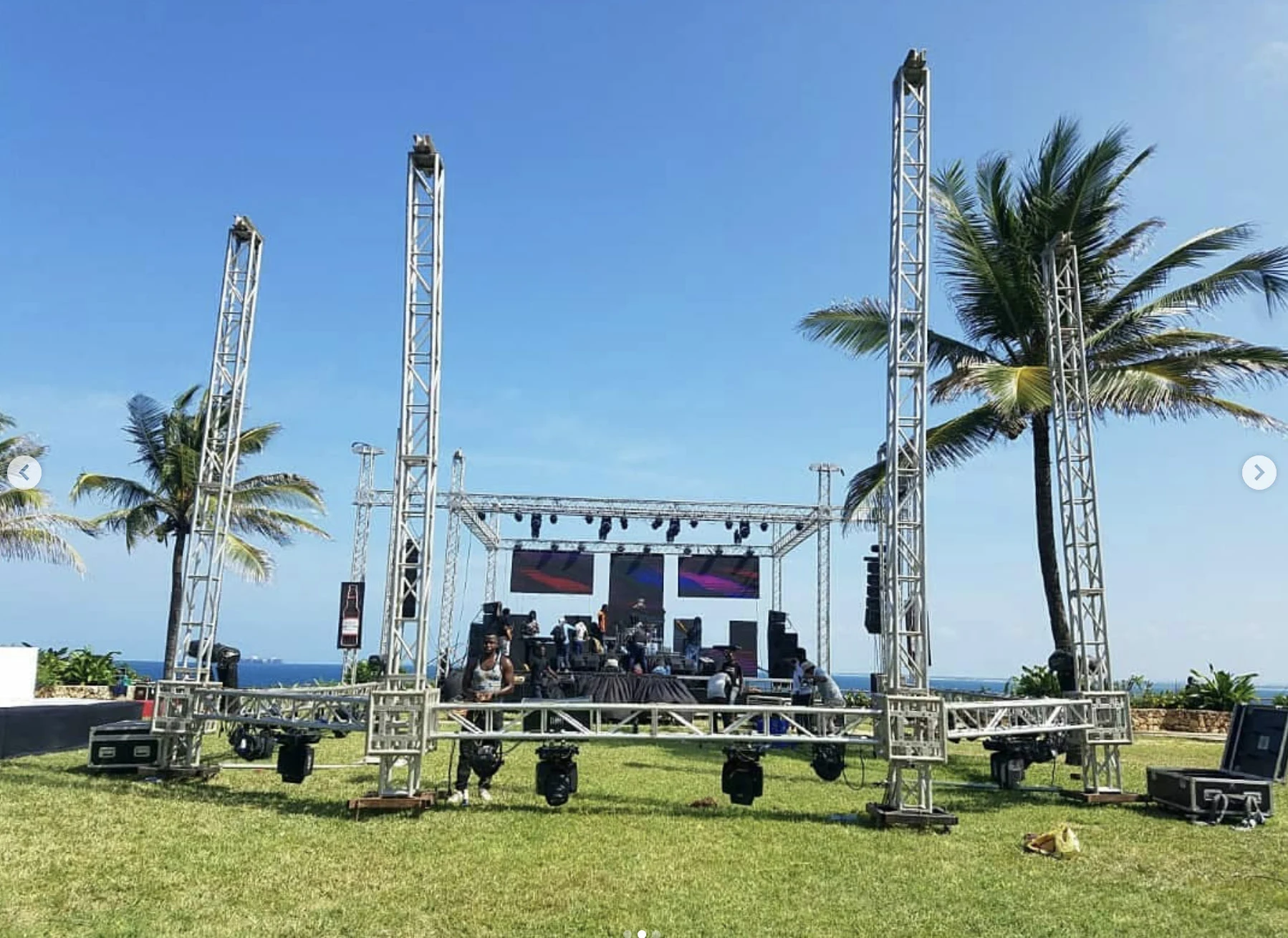 Outdoor stage and truss structures in a palm-lined venue